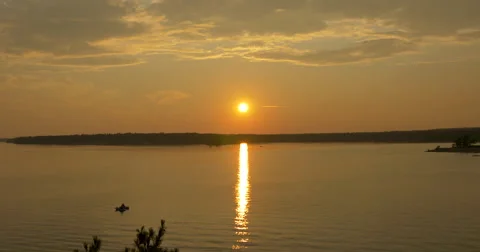 Canoe floating on the lake at sunset at Killbear Provincial Park Stock Footage 58815410