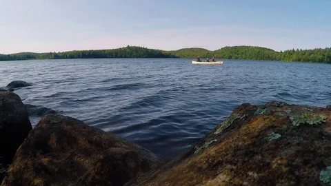 Canoe on lake in the sun Stock Footage 81923046