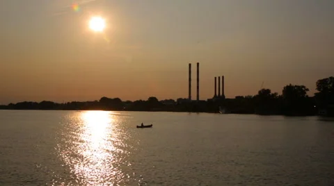 Canoe on the river, passing over Sun's reflection in the water Stock Footage 41707646