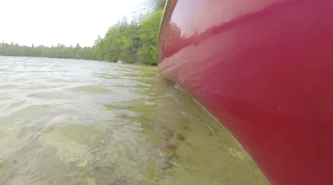 Canoe slowly navigating on a lake Video stock 39652723