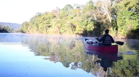 Canoe trip down calm river Video stock 56154799