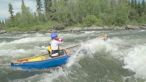 Canoeing into river rapids in slow motion Stock Footage 88300111