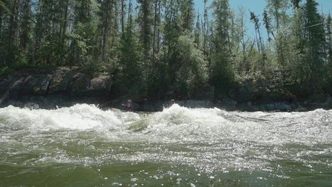 Canoeing into river rapids in slow motion Stock Footage 88343579