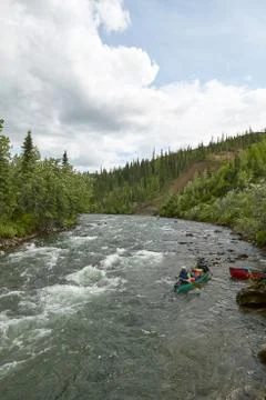 Canoeing on river rapids in wild, remote Alaska Foto stock