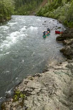 Canoeing river rapids in wild, remote Alaska Stock Photos
