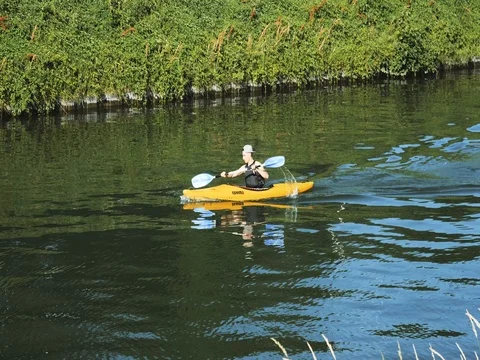 Canoeist on river in France preparing for competition Stock Footage