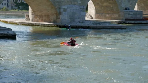 Canoeists on the Danube as it passes through Regensburg Stock Footage 111459800