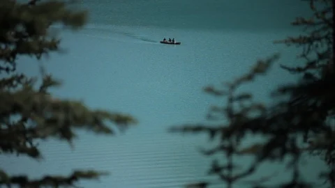 Canoers cross a lake in Alberta Stock Footage 90876800