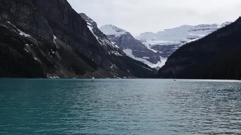 Canoers cross a lake in Alberta Stock Footage 90876816