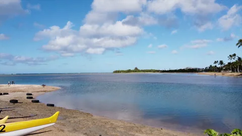 Canoes amidst blue skies and ocean in Honolulu Stock Footage