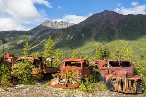 Canol road An array of abandoned rusty post war trucks that lay rusting aw... Stock Photos