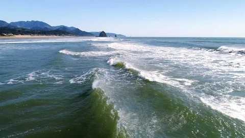 Canon Beach Waves Flyover with Haystack Rock in Distance Stock Footage 124678703