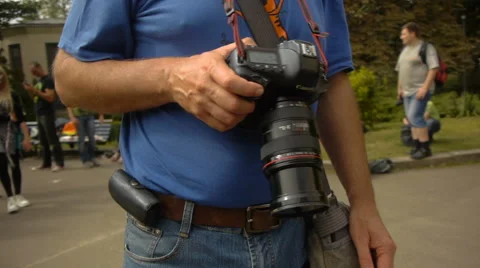 Canon camera hanging from a complete man in the neck Stock Footage 68208906