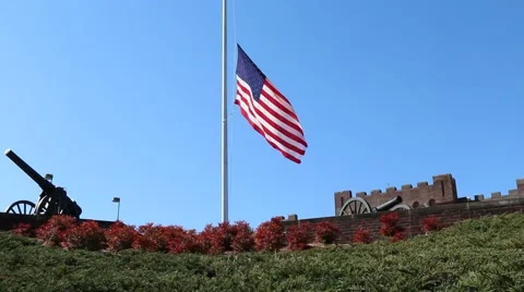 Canon in Foreground of US Flag at Half Mast Stock Footage 69223086