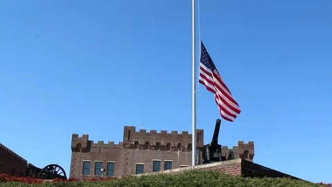 Canon in Foreground of US Flag at Half Mast Stock Footage 69223230