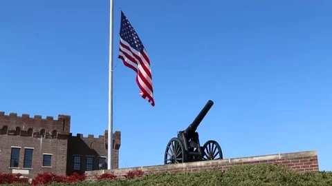 Canon in Foreground of US Flag at Half Mast with Building in Background Stock Footage 69223323