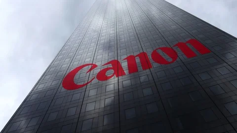Canon Inc. logo on a skyscraper facade reflecting clouds, time lapse. Editorial Video stock 81111392