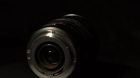Canon wide angle macro zoom lens rotates on black background, dark Stock Footage 333479436