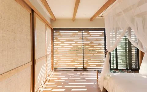 Canopy bed in tranquil modern, luxury home showcase interior bedroom Stock Photos
