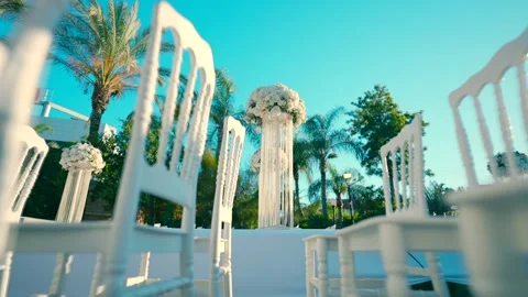 Canopy ceremony in the garden. White chairs stand in rows . Stock Footage 248463595