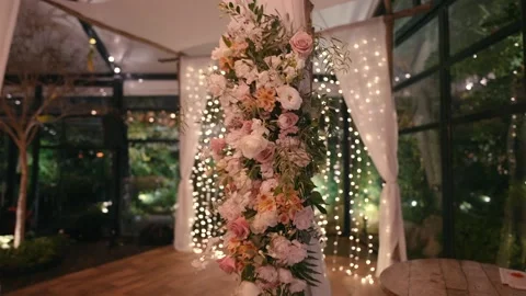 A canopy standing in an arched pavilion with beautiful flowers and LED lamps. Stock Footage 232847077