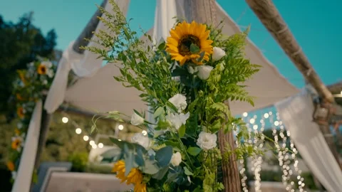 A canopy stands under the sky and decorated with sun flowers and LED lamps. Stock Footage 242015783