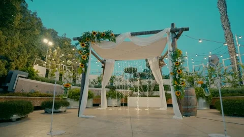 A canopy stands under the sky and decorated with sun flowers and LED lamps. Stock Footage 242015868