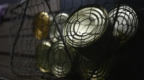 Cans full of meat inside basket in slow motion Stock Footage 44325028