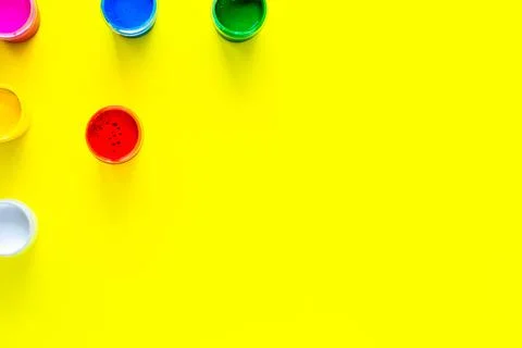 Cans of multi-colored paint are arranged in a triangle Stock Photos