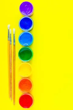Cans of paint stand in a line on the side, the colors are displayed Stock Photos