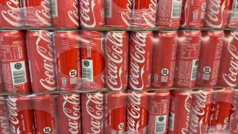 Cans of soda stacked in packaging with logos visible Stock Footage 331462042