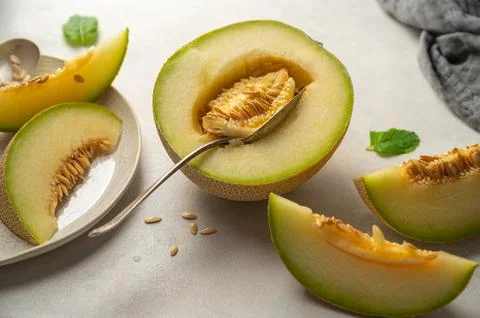 Cantaloupe, melon fruit slice over bright background. Stock Photos
