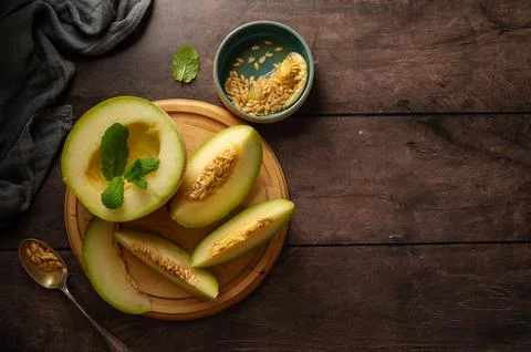 Cantaloupe, melon fruit slice over dark background. Healthy snack or dessert Stock Photos