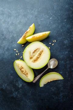 Cantaloupe, melon fruit slice over dark background. Top view Stock Photos