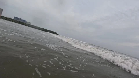 Canted-angle: Waves roll up on the shore... | Stock Video | Pond5
