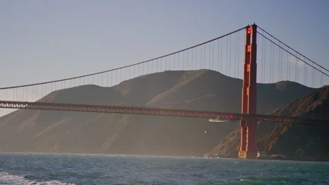 Canted view of Golden Gate Bridge north side with ocean spray at sunset Stock Footage 242832462