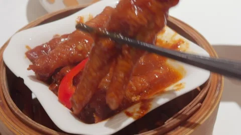 Cantonese Dim Sum Chicken Feet Lifted by Chopsticks in Bamboo Steamer Stock Footage 339399710