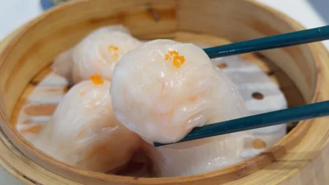 Cantonese Har Gow Shrimp Dumpling Lifted by Chopsticks in Bamboo Steamer Stock Footage 339399328