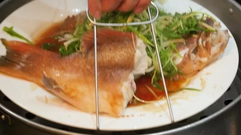Cantonese Style Steamed Whole Fish with Scallions and Soy Sauce Stock Footage 344231702