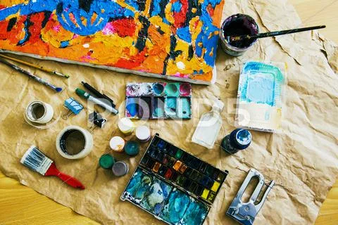 Canvas and painting tools on brown paper Stock Photos