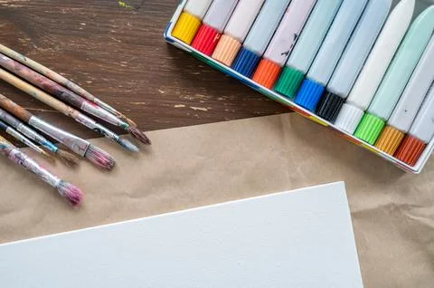 Canvas with brushes and paint ready to use Stock Photos