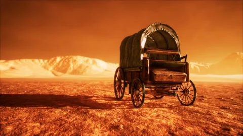 Canvas covered retro wagon in desert at sunset Stock Footage 129070019