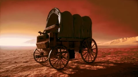 Canvas covered retro wagon in desert at sunset Stock Footage 141461079