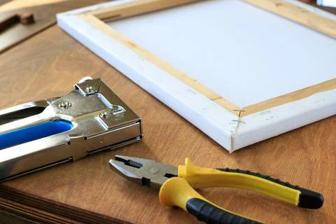 Canvas Stretching Tools with Stapler and Pliers Beside Stretcher Frame Stock Photos
