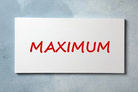 Canvas with word Maximum on light blue textured background Stock Photos