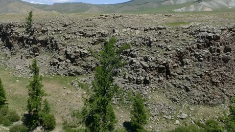 Canyon and a shallow river on the background of mountains under a cloudy sky. Stock Footage 90669833