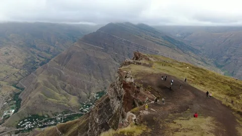 Canyon with a fast mountain river flowing along its bottom. Village of Goor Stock Footage 314876269