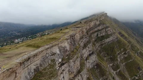 Canyon with a fast mountain river flowing along its bottom. Village of Goor Stock Footage 314876513