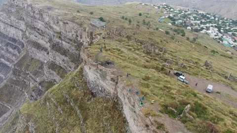 Canyon with a fast mountain river flowing along its bottom. Village of Goor Stock Footage 314876547