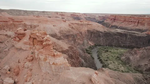 Canyon with red rocks, stone pillars and river flowing. Sharyn Canyon Video stock 219945927